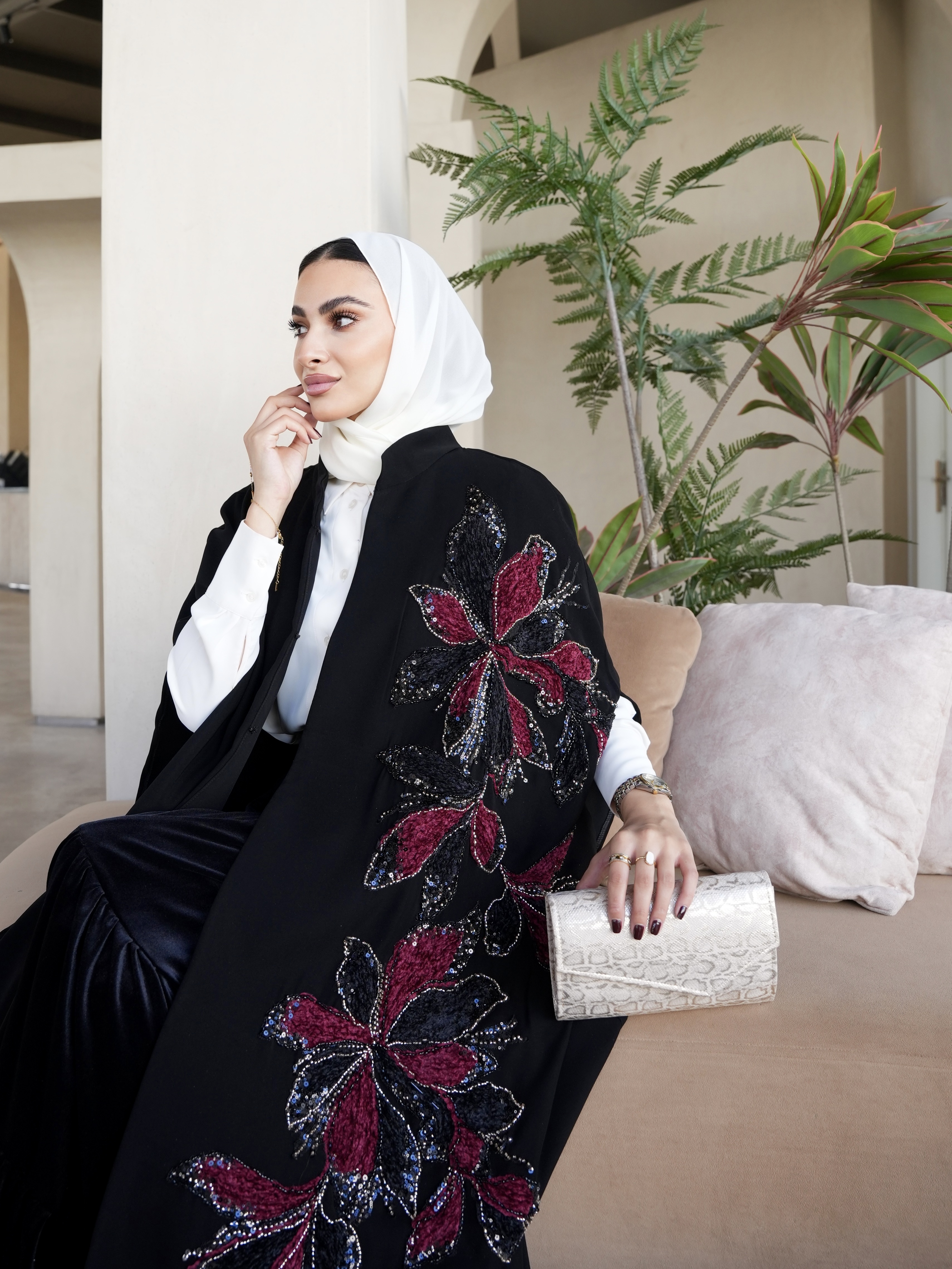 Red embroidered black cape