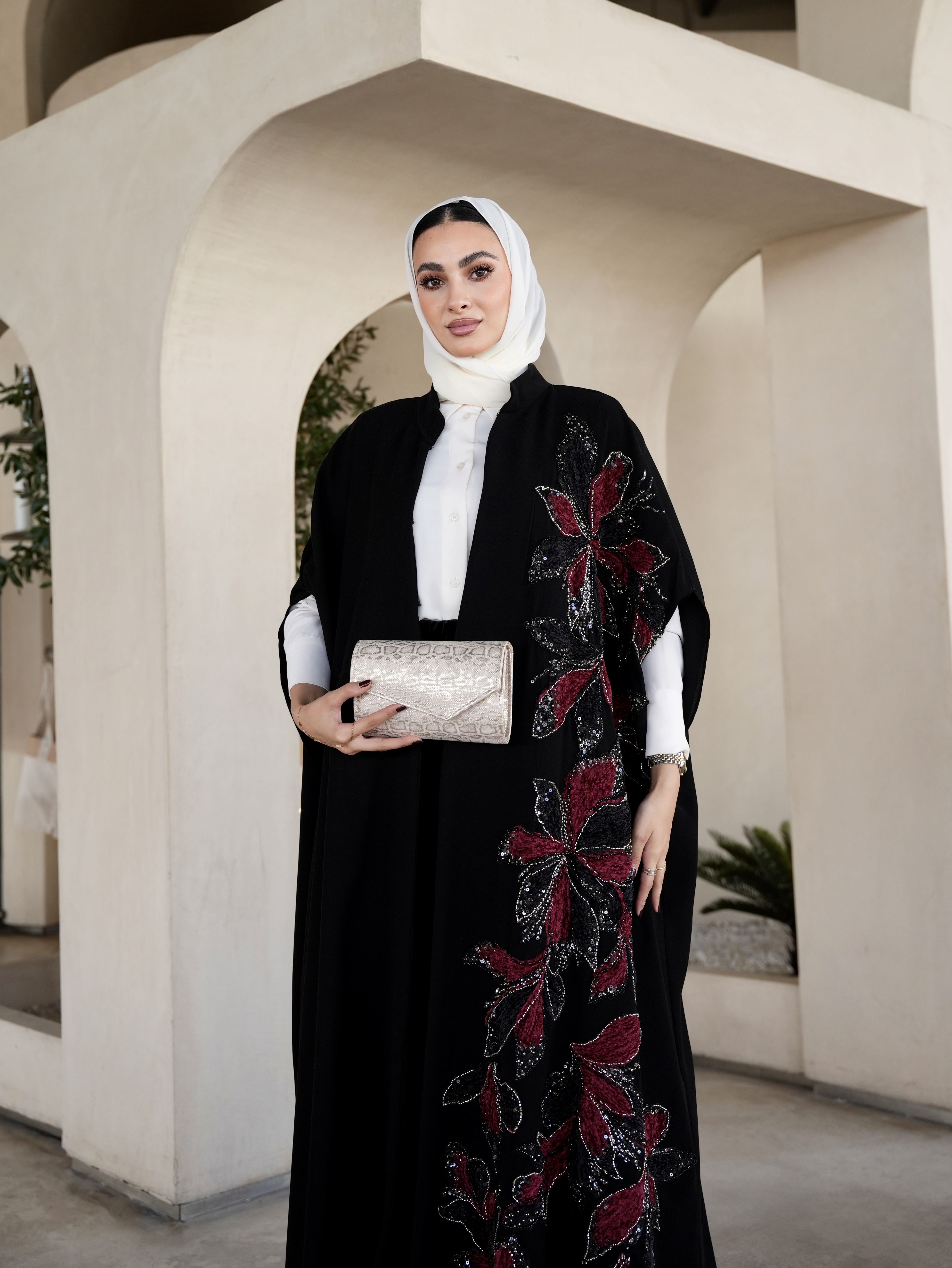 Red embroidered black cape