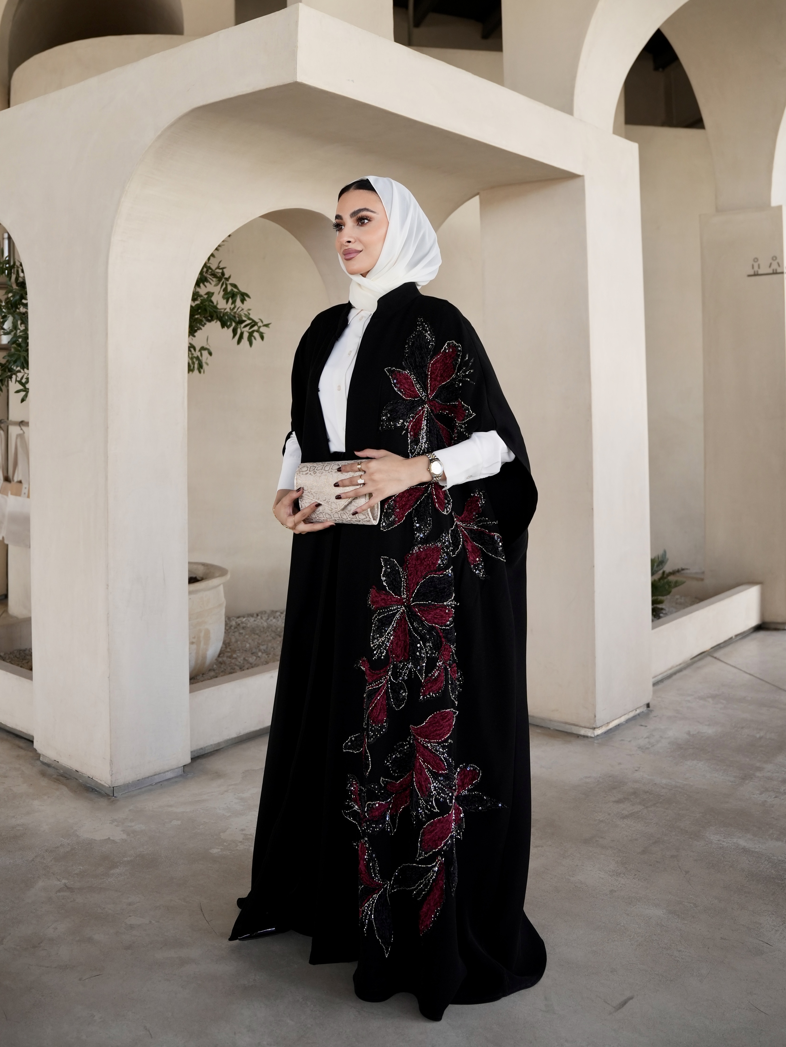 Red embroidered black cape
