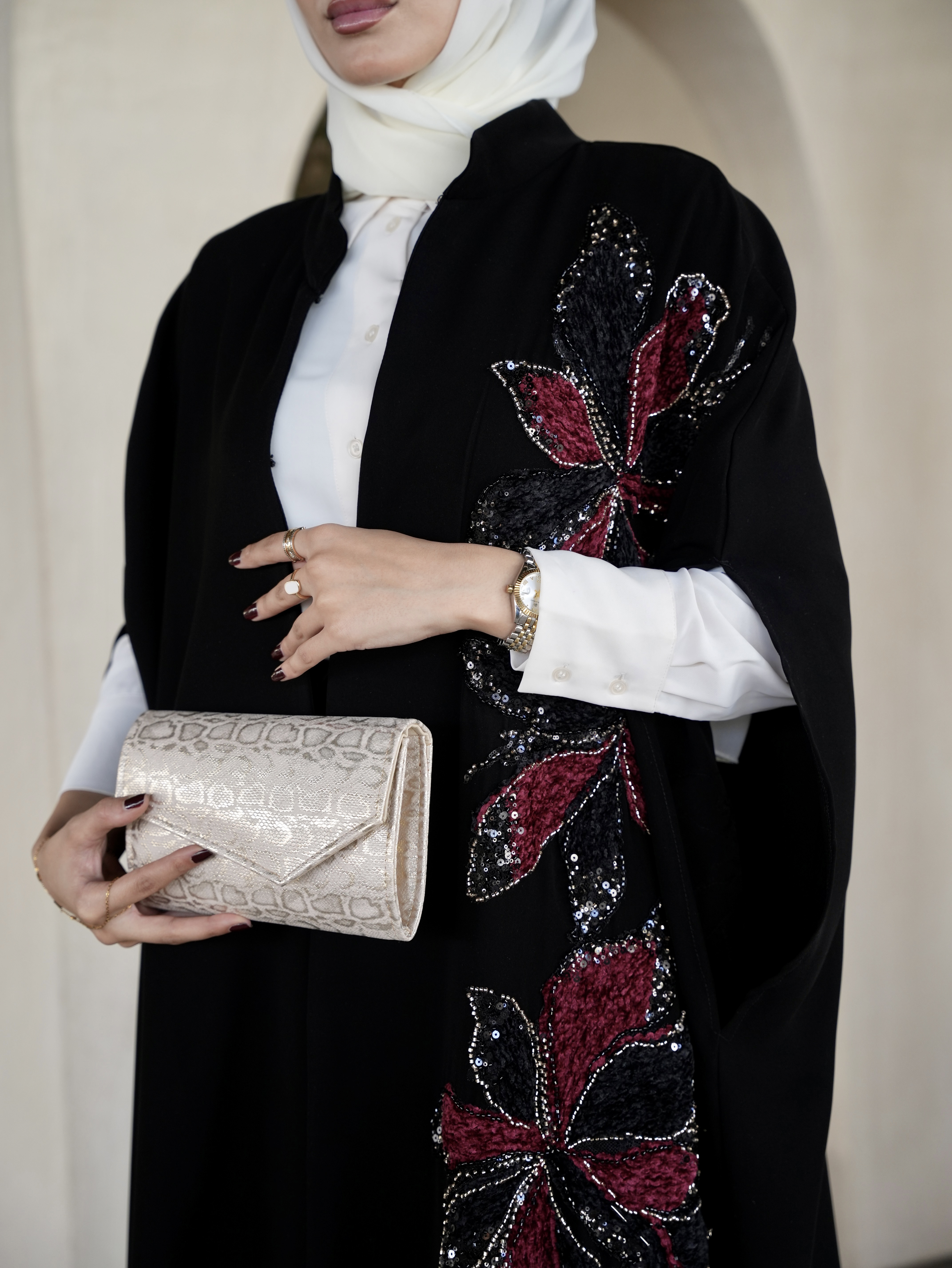 Red embroidered black cape