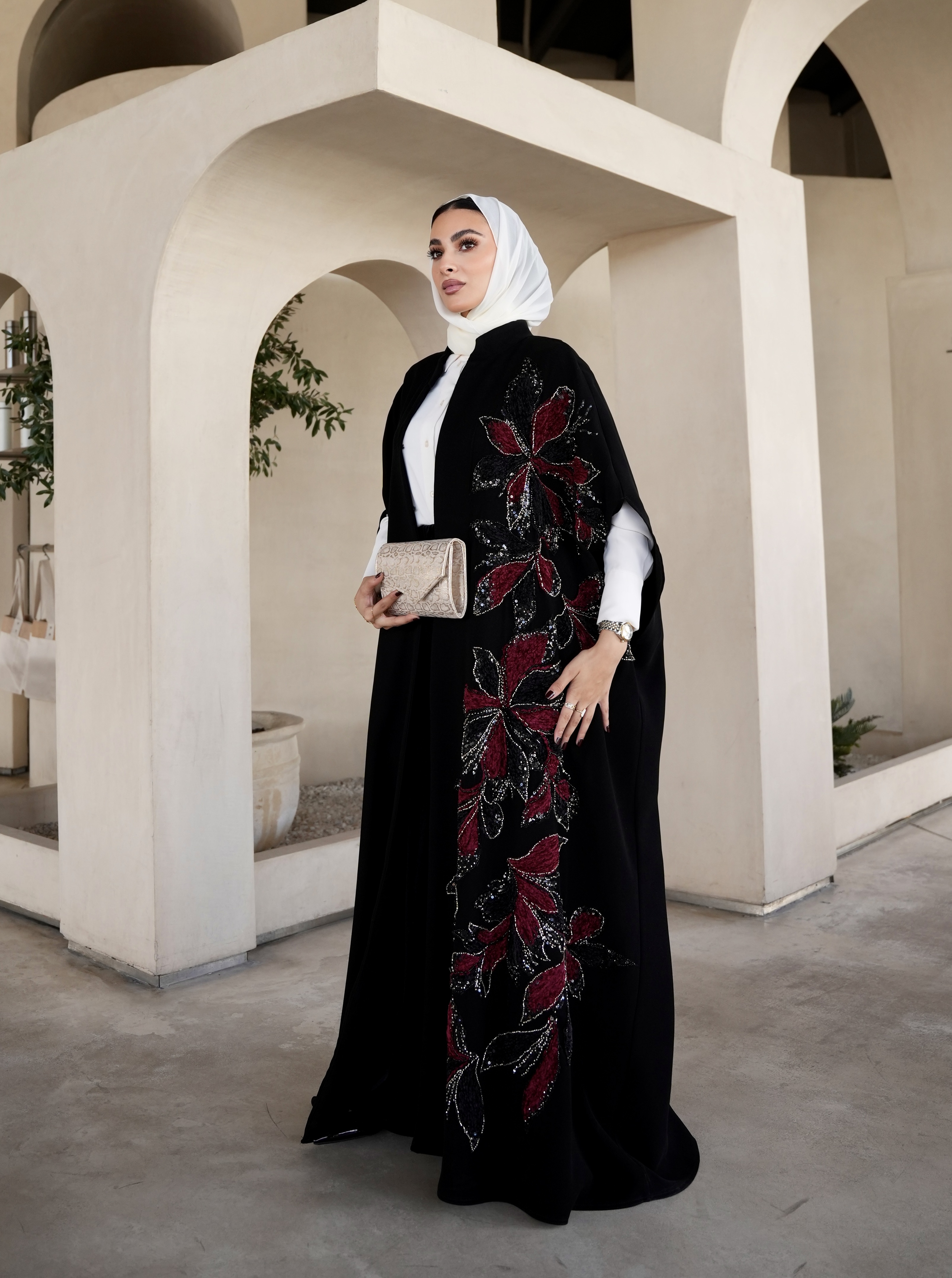 Red embroidered black cape